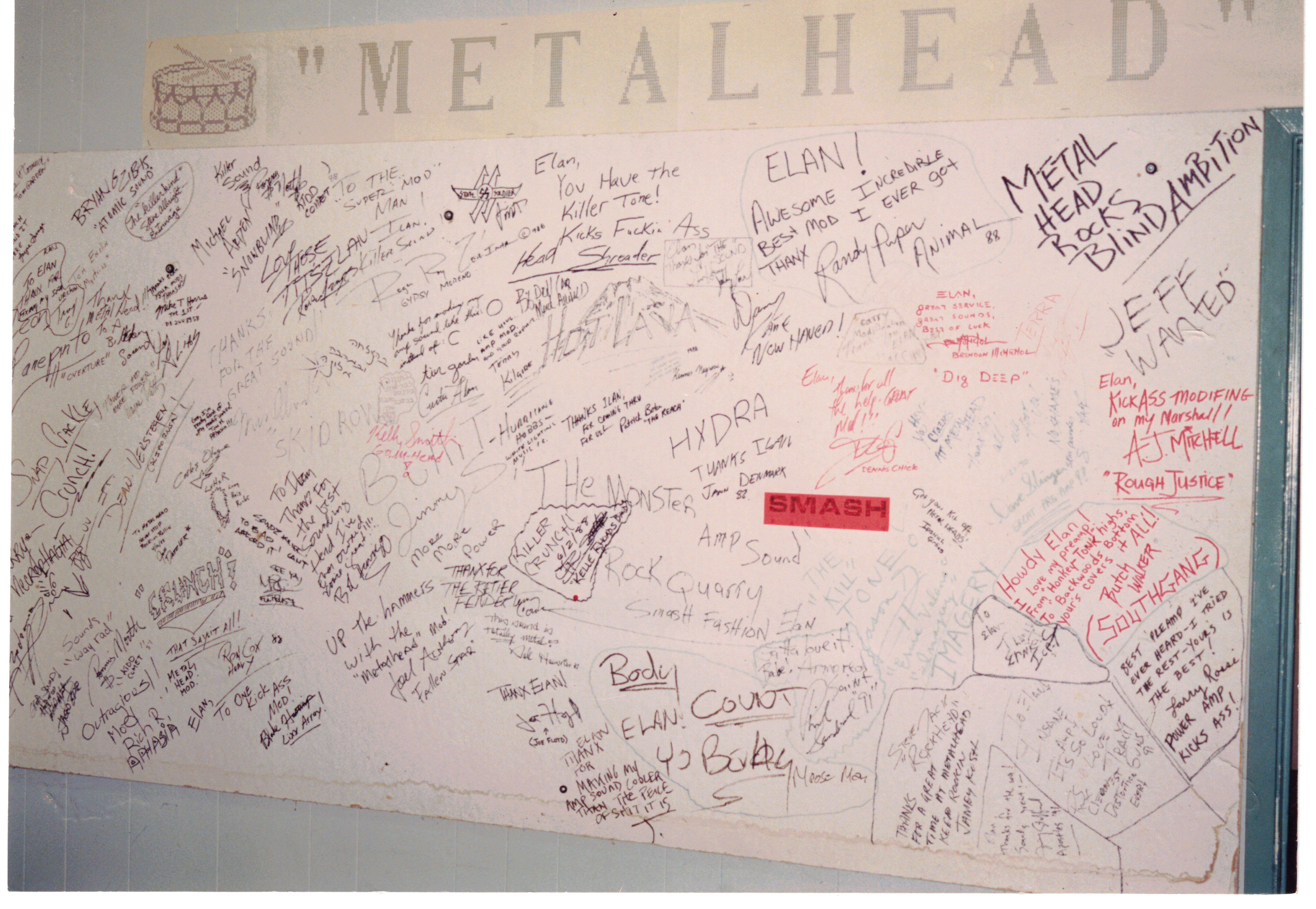 Original MetalHead Electronics wall with musician signatures